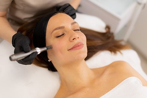 Woman relaxing while undergoing microneedling treatment