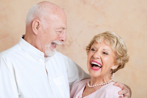 Smiling man and woman with dentures