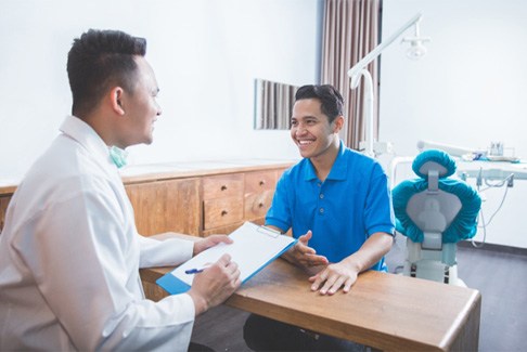 A dentist explaining implant treatment to a patient