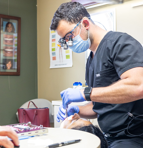 Dental team member smiling at dentistry patient