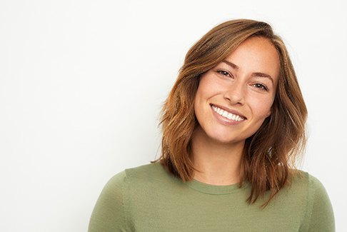 woman smiling after getting Invisalign 