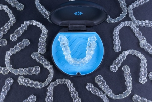 Invisalign trays in and around a carrying case