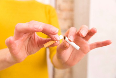 a patient breaking a cigarette in half