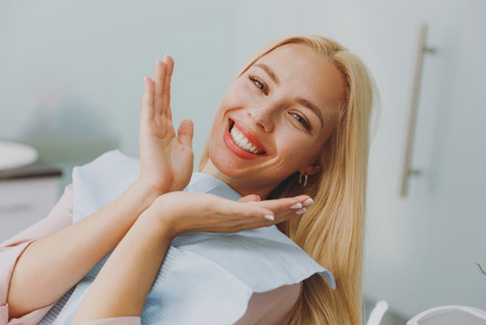 a patient smiling after completing her smile makeover