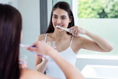 Woman using oral care products at home