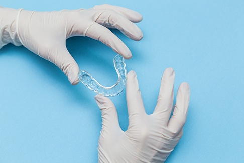 Dentist holding a Spark clear aligner tray
