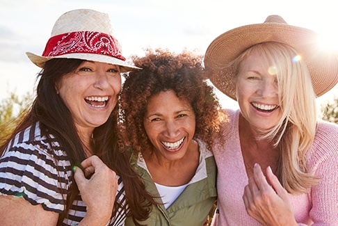 Patient in Sterling Heights smiling with friends in the sun
