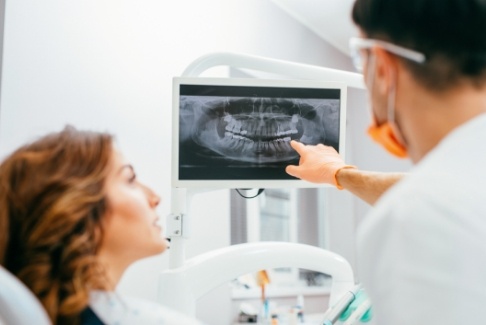Dentist and dental patient looking at digital x-rays