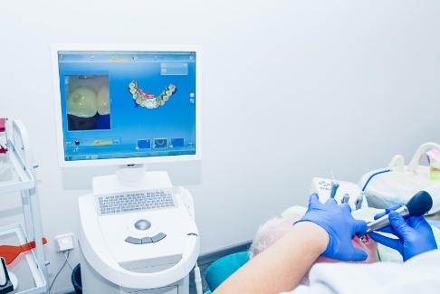 Dentist looking at smile captured by digital impression system