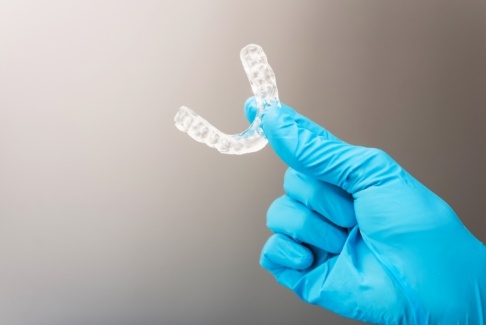 Hand holding an occlusal splint for T M J dysfunction