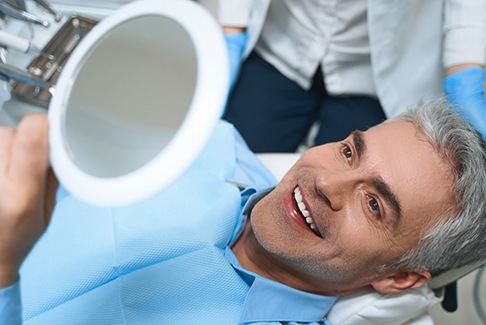 a patient in Sterling Heights smiling after receiving veneers 