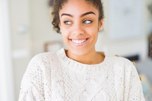 a woman smiling after getting veneers in Sterling Heights