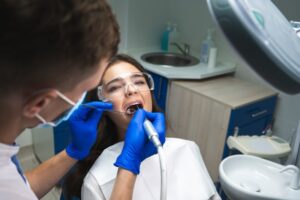 Dentist performing root canal on patient.